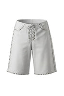White leather shorts with studded accents from Double A's Callie collection, shown in a stylish close-up image.
