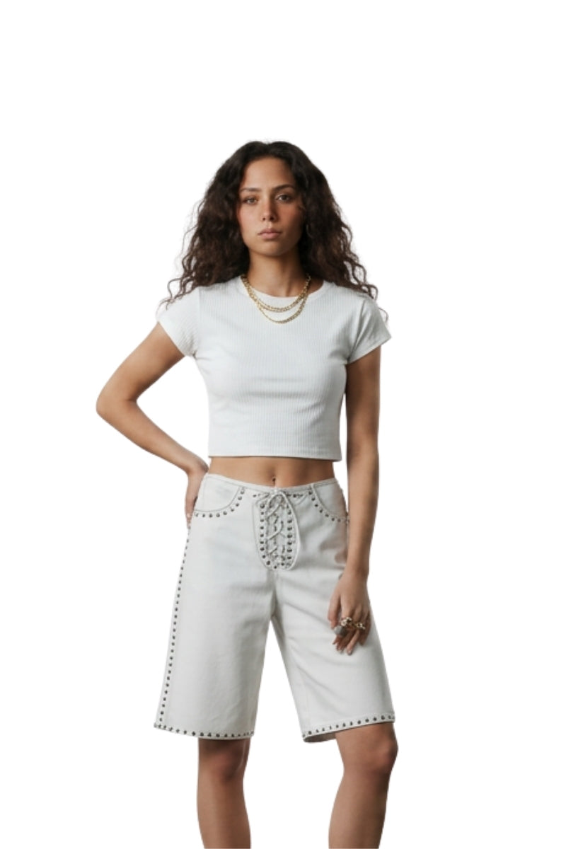 White Callie leather studded shorts by Double A, showing a close-up of the stylish, fitted shorts with metal stud detailing.