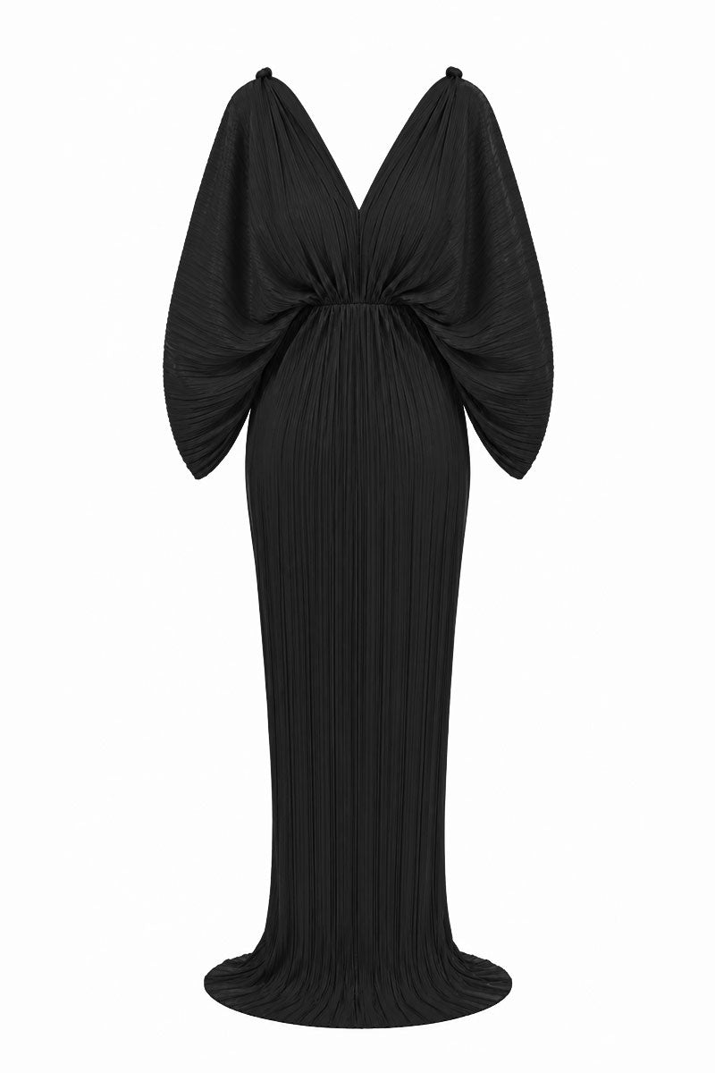 Black Candela dress by Maylé Vásquez, elegant gown with flowing fabric and stylish design, perfect for formal occasions.