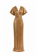 Gold Candela dress by Maylé Vásquez, elegant gown with flowing fabric and intricate detailing, perfect for formal occasions.
