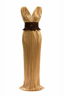 Elegant gold Candela dress gown by Maylé Vásquez, featuring flowing fabric and intricate detailing, perfect for formal occasions.