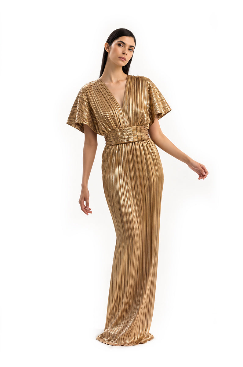 Elegant gold Candela gown by Maylé Vásquez featuring flowing fabric and intricate detailing, perfect for formal occasions.