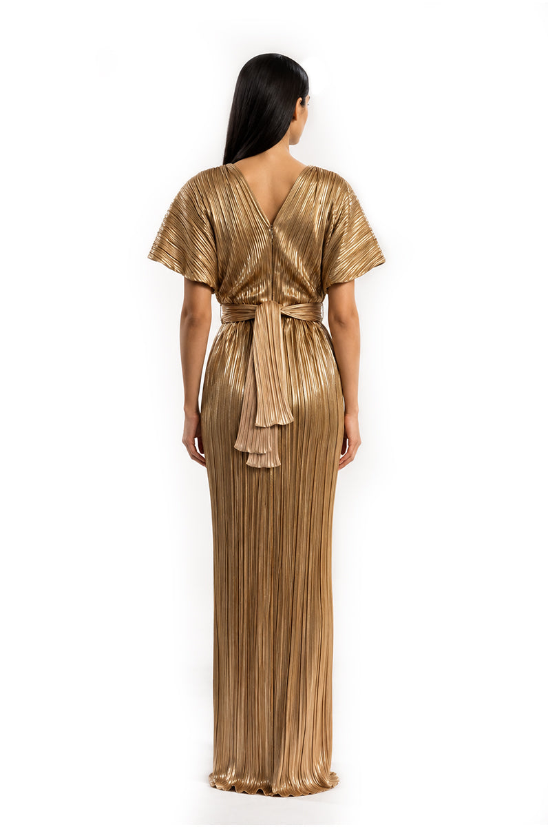 Gold Candela gown by Maylé Vásquez featuring elegant fabric and intricate design, perfect for formal occasions.