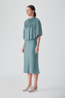 MASTANI TIYA hand-smocked Saxon cape top featuring intricate detailing and flowing fabric in a stylish, elegant design.