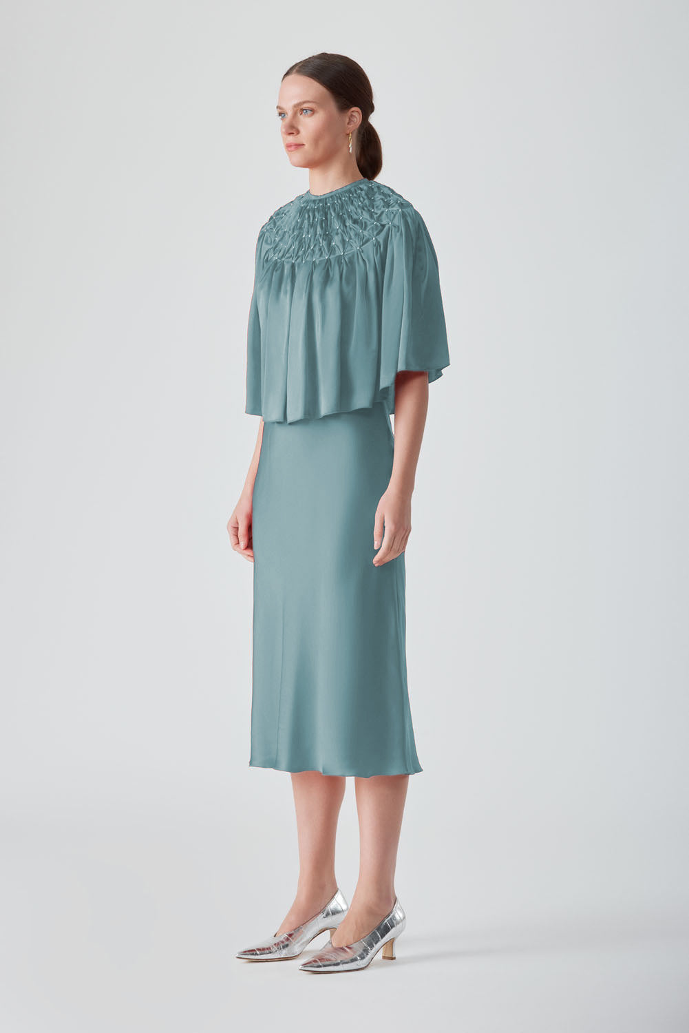 MASTANI TIYA hand-smocked Saxon cape top featuring intricate detailing and flowing fabric in a stylish, elegant design.