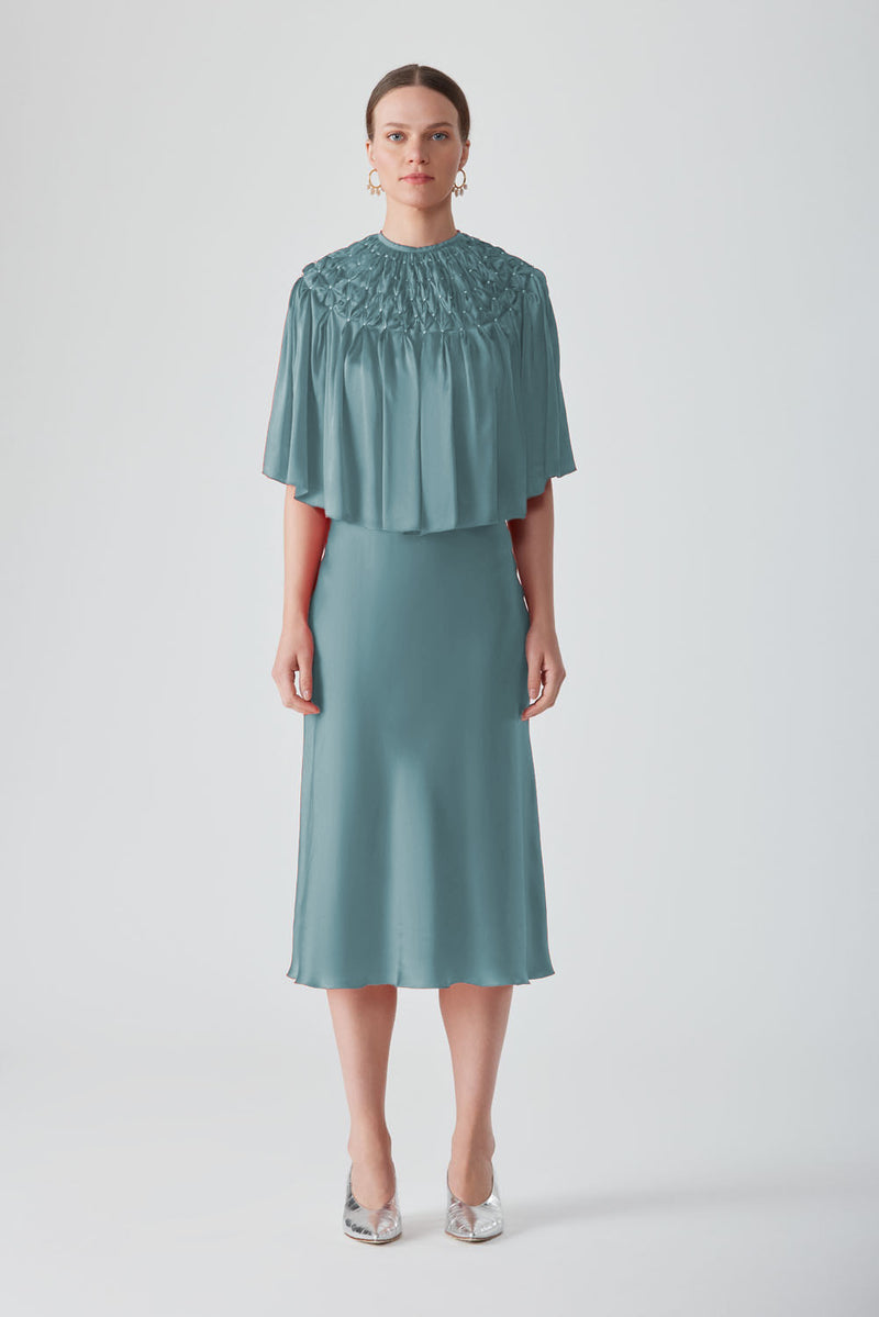 TIYA HAND-SMOCKED CAPE IN SAXON