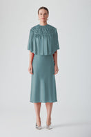 Hand-smocked SAXON cape by MASTANI, stylish and elegant tops with intricate detailing, perfect for fashionable layering.