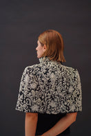 Nadya Shah Cape Anais jacket in soft fabric, styled with a flowing design and elegant drape, shown in a neutral color.