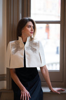 Nadya Shah Cape Eclat Ivory jacket displayed on a model, showcasing elegant ivory fabric and stylish design.