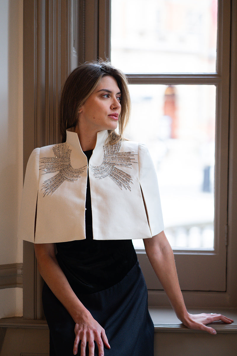Nadya Shah Cape Eclat Ivory jacket displayed on a model, showcasing elegant ivory fabric and stylish design.