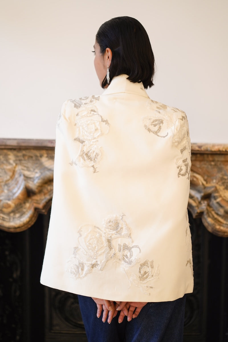 Nadya Shah Lumiere Cape jacket shown from the back, featuring flowing fabric and a stylish, elegant design perfect for layering.