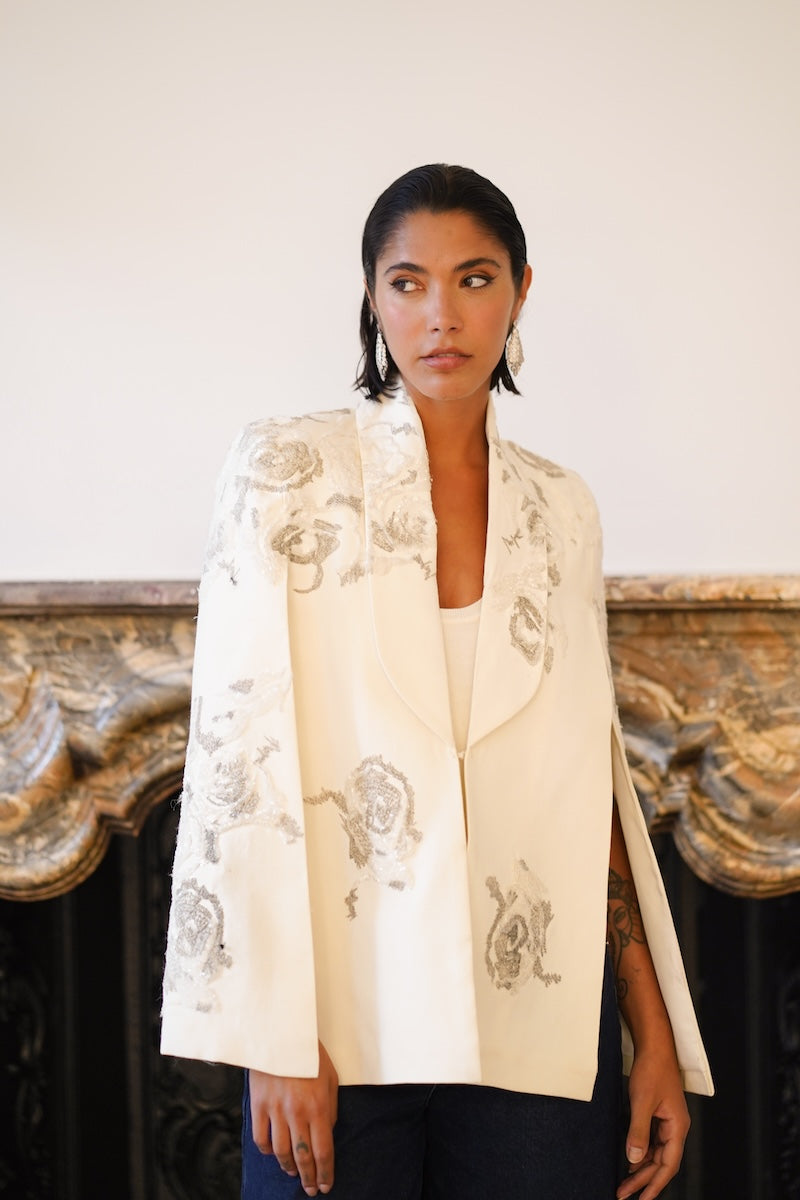 Nadya Shah Lumiere Cape jacket shown from the front, featuring elegant design and lightweight fabric in a stylish outerwear piece.