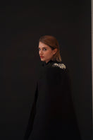 Nadya Shah Cape Nocturne jacket with wide collar and flowing black fabric, stylish outerwear for elegant winter wear.
