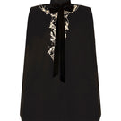 Nadya Shah Cape Nocturne jacket displayed from the front, featuring a sleek, dark-colored design with intricate detailing.
