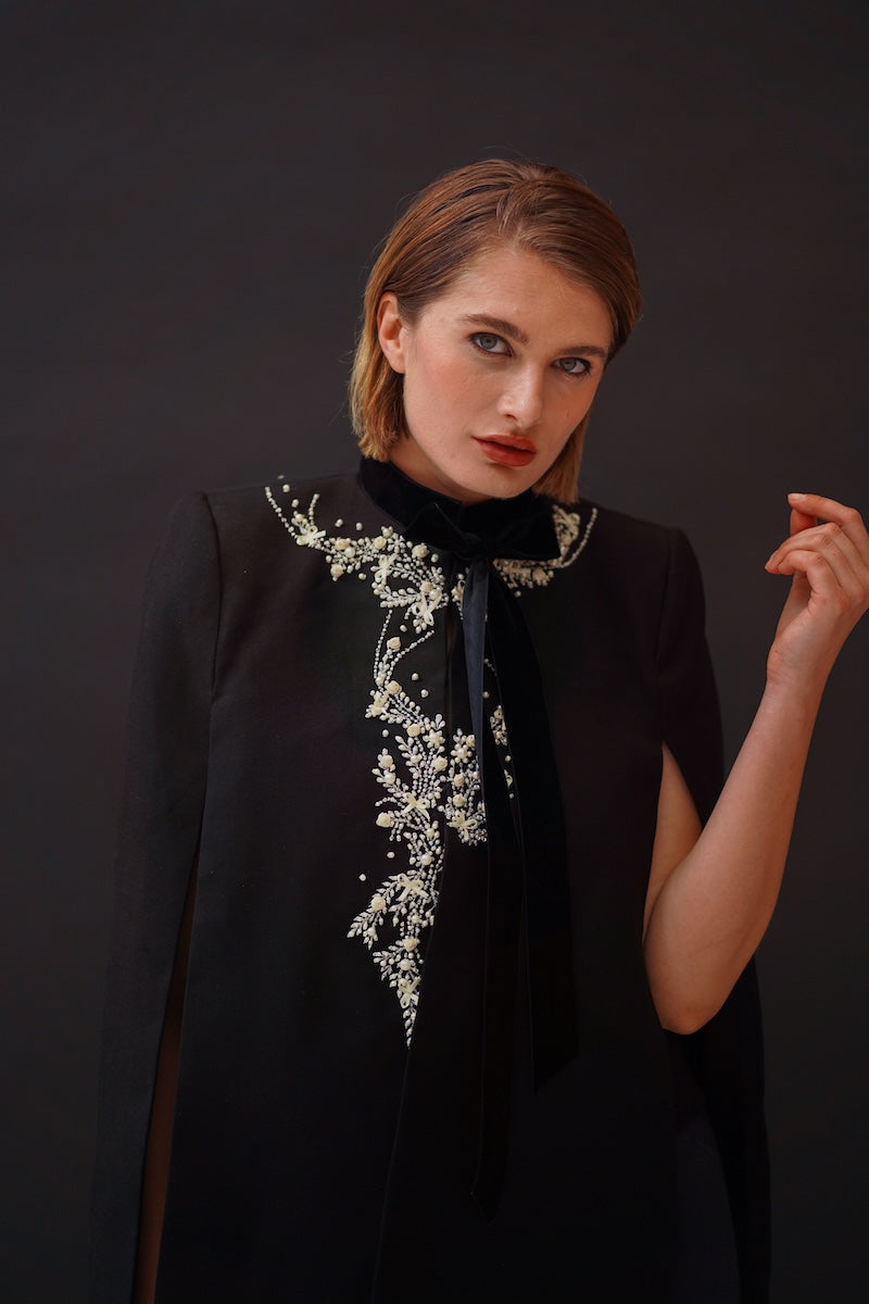 Nadya Shah Cape Nocturne jacket displayed on a model, stylish black outerwear with a sleek, modern design.