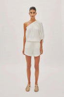 Labeca white linen Capri shorts paired with a one-sleeve top, showcasing a stylish and lightweight summer outfit.