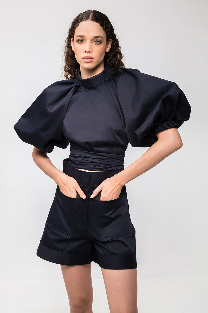 Navy blue Capriccio shorts by ANA + MARIA, featuring a comfortable fit and casual style, shown on a model.