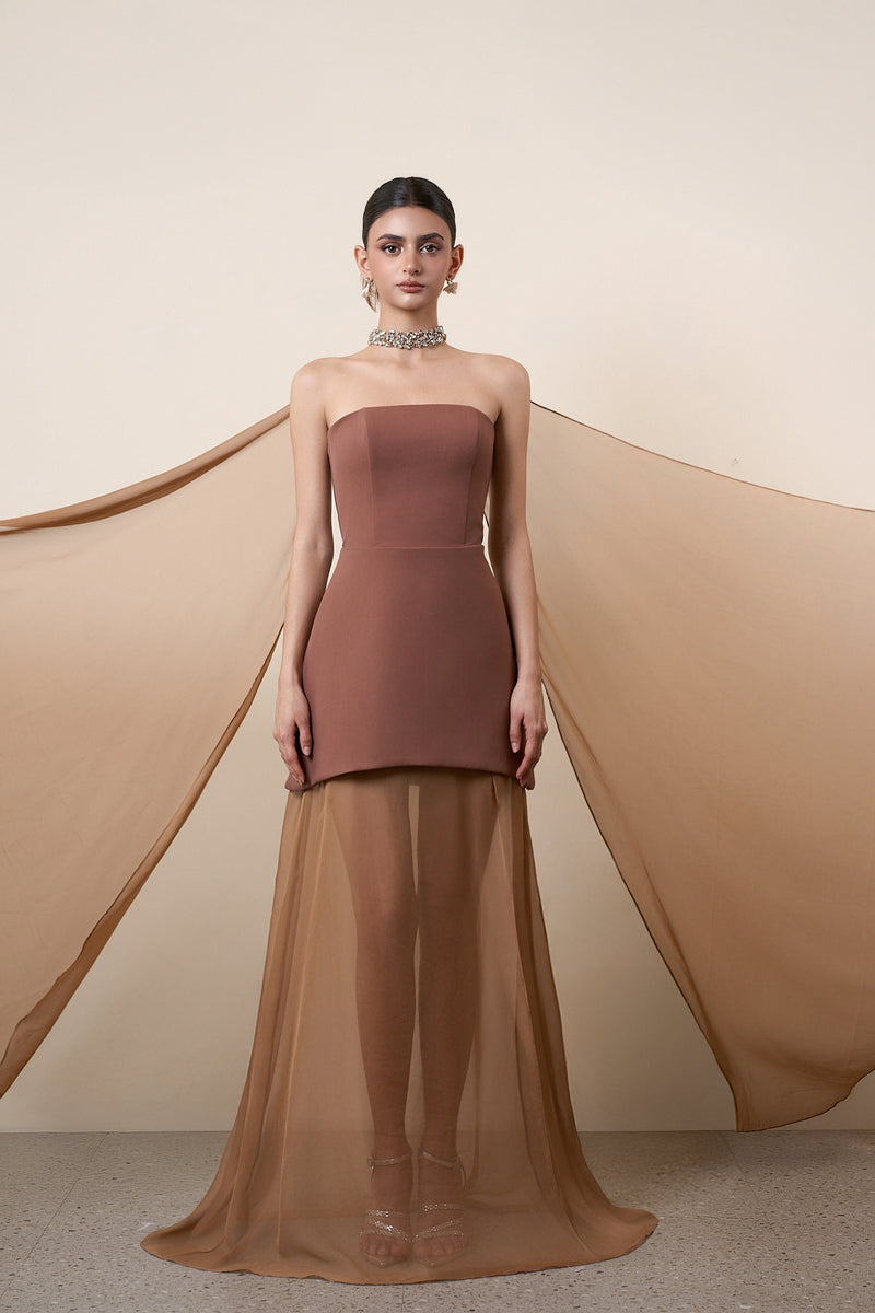 Elegant brown strapless gown with a cape from HACCHIC COUTURE, showcased on a model with flowing fabric and sophisticated design.