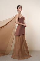 Elegant brown strapless gown with matching cape by HACCHIC COUTURE, featuring a flowing silhouette and sophisticated design.