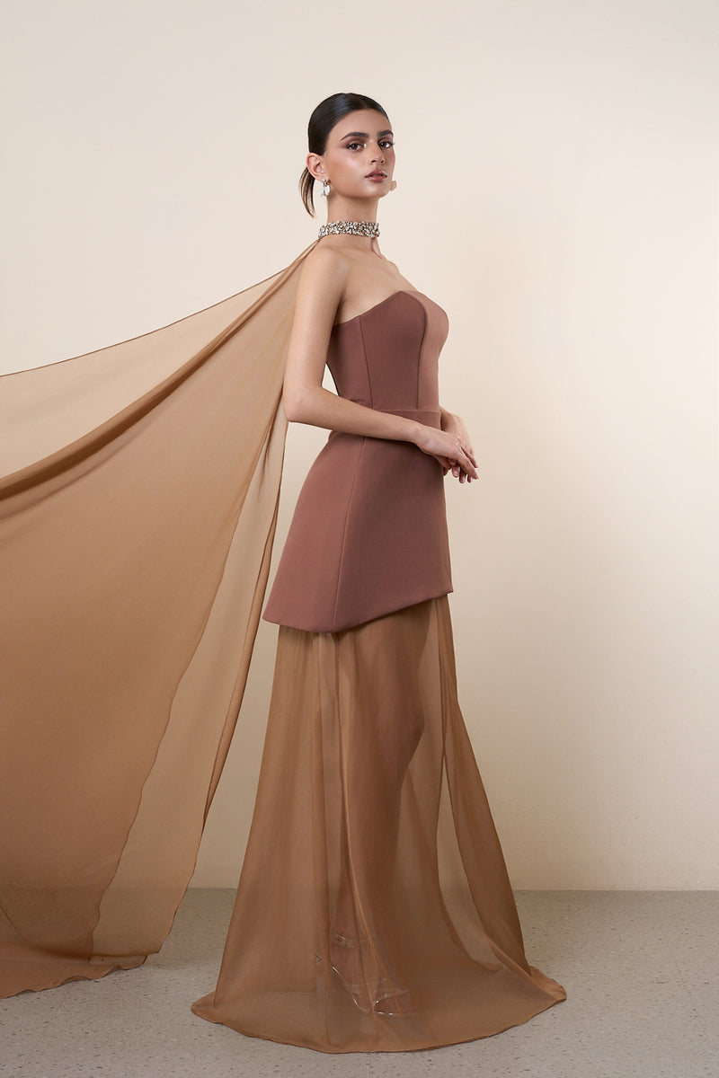 Elegant brown strapless gown with matching cape by HACCHIC COUTURE, featuring a flowing silhouette and sophisticated design.
