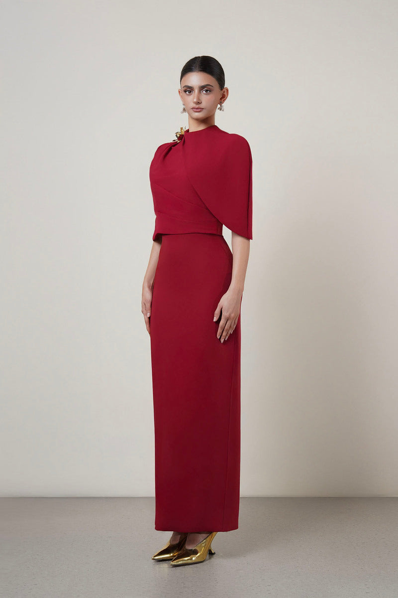 Red MOAZ maxi dress by HACCHIC COUTURE displayed on a model, showcasing its elegant flowing fabric and stylish design.