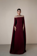 Elegant burgundy long sleeve gown by HACCHIC COUTURE, featuring a flowing silhouette and sophisticated design.
