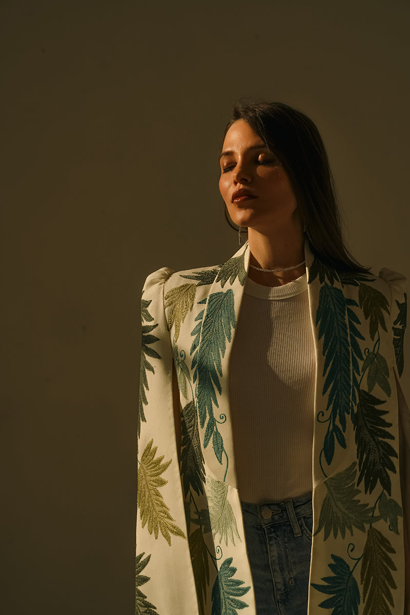 Nadya Shah Cara Leaf Cape jacket featuring a vibrant leaf pattern, lightweight fabric, and a flowing, stylish design.