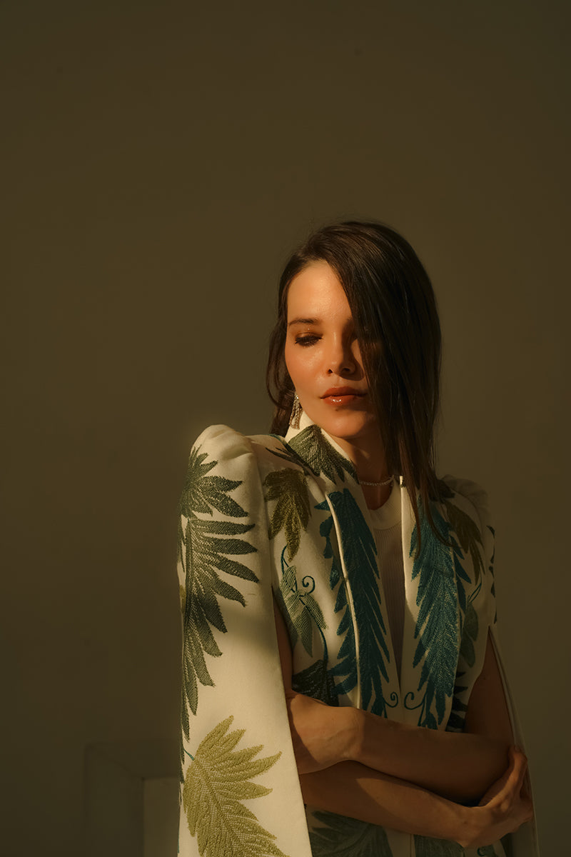 Nadya Shah Cara Leaf Cape jacket featuring a leafy, nature-inspired design with flowing fabric and open front style.