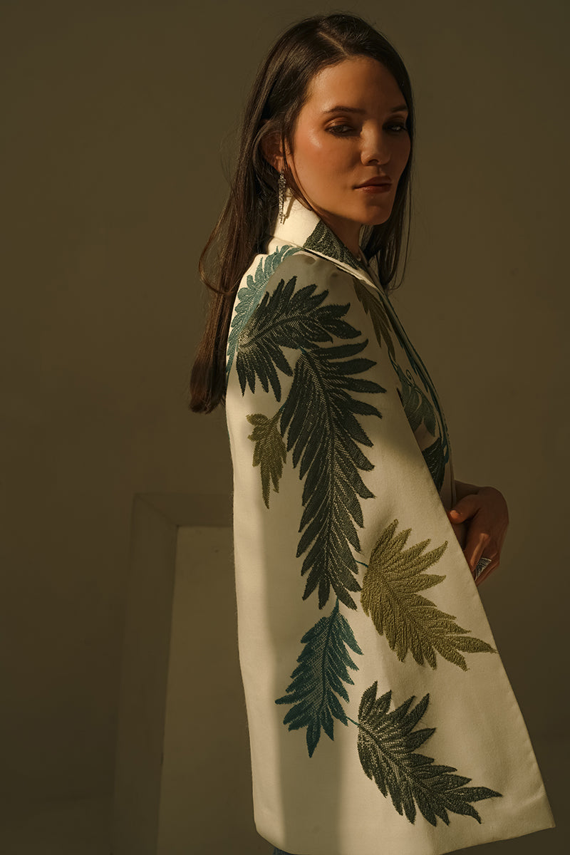 Nadya Shah Cara Leaf Cape jacket with a vibrant leaf pattern, flowing fabric, and stylish design for a fashionable layered look.