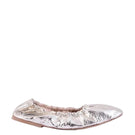 A pair of AERA Carla Gold Foil-Effect Flats with shiny gold finish and sleek slip-on design on a white background.