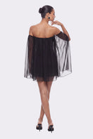 Black Carmen mini dress by Nana Jacqueline featuring off-shoulder design and elegant fit, displayed on a model.