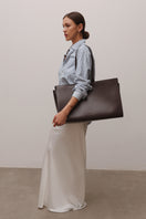 Poelle Carolyn medium suede tote bag in brown with shoulder strap and minimalist design, perfect for everyday use.