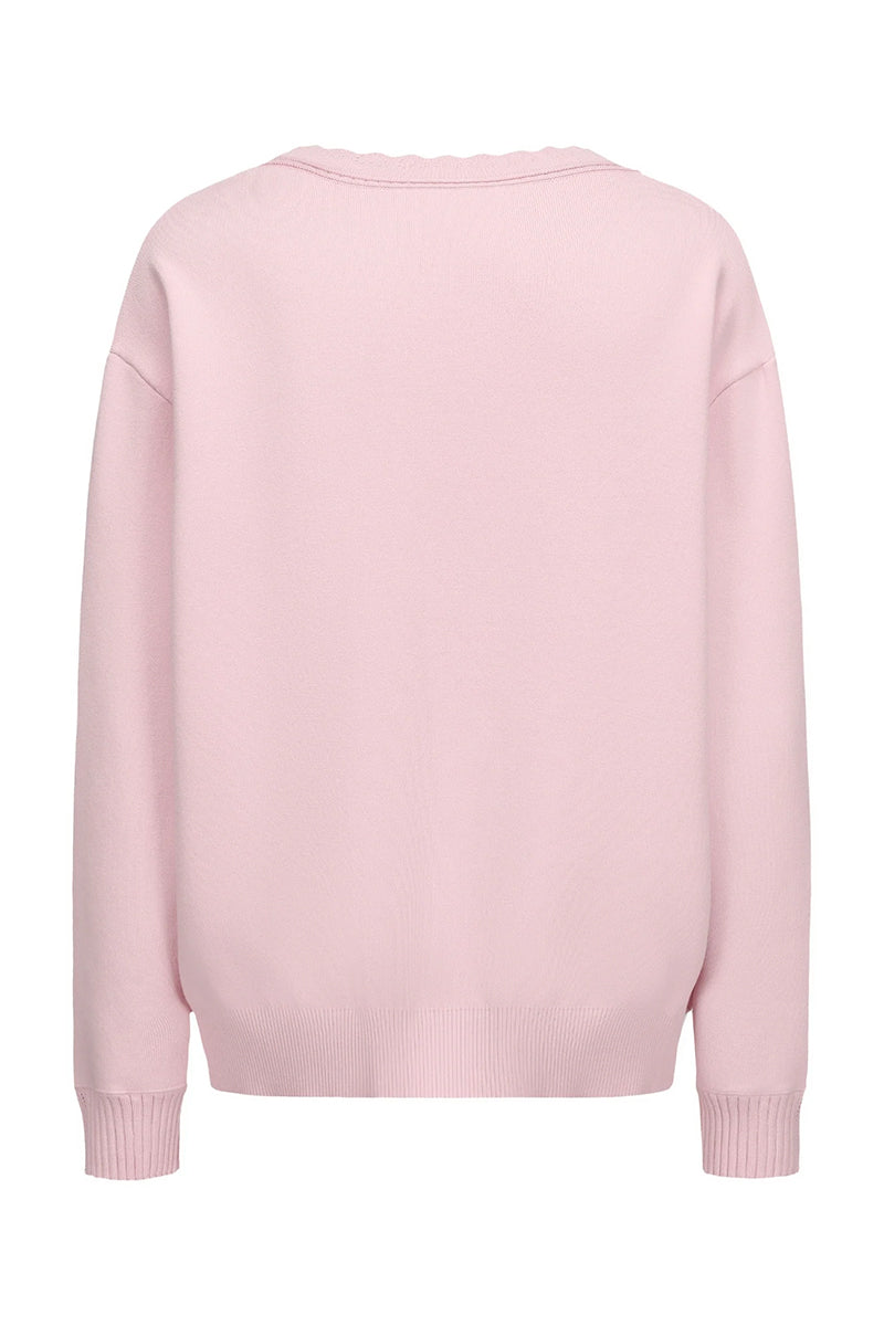 Pink Nana Jacqueline Carrie cardigan displayed from the back, featuring soft knit fabric and a relaxed fit.