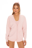 Pink Nana Jacqueline Carrie cardigan with long sleeves and ribbed cuffs, styled in a cozy, casual look.