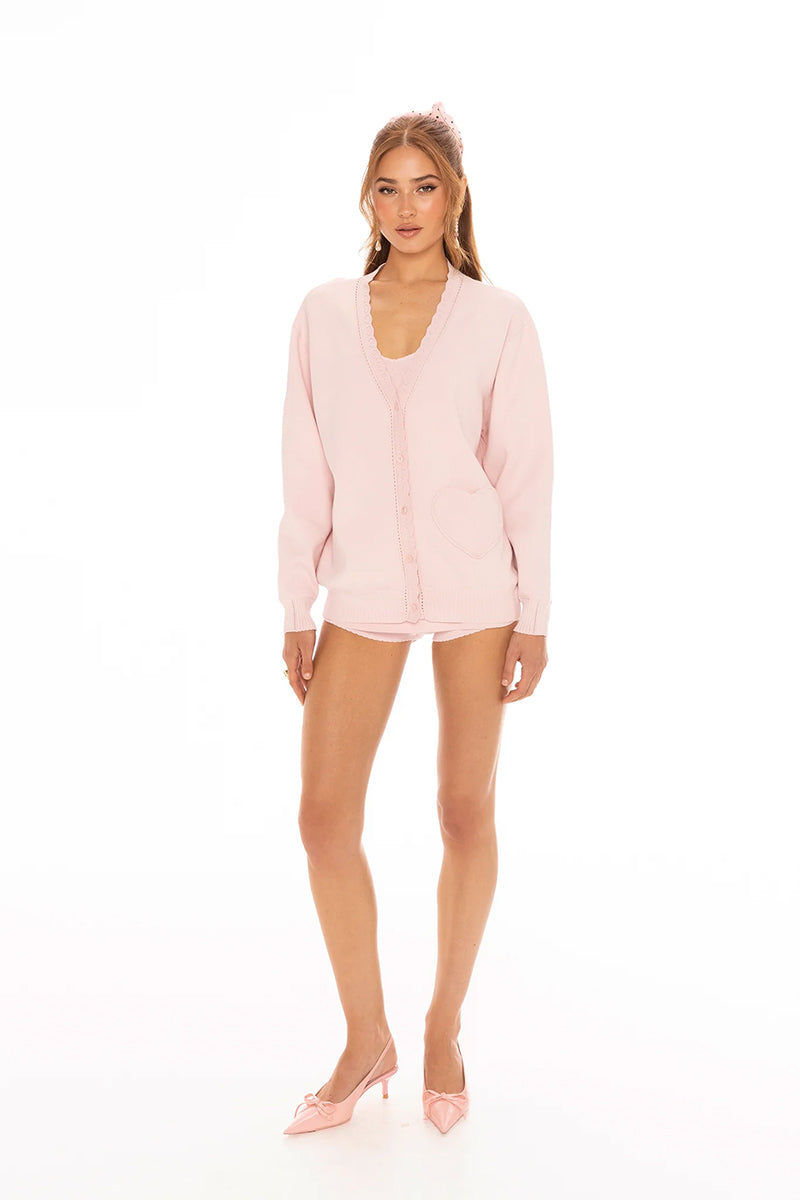 Pink Nana Jacqueline Carrie cardigan displayed on a model, featuring a soft knit fabric and button-front design.
