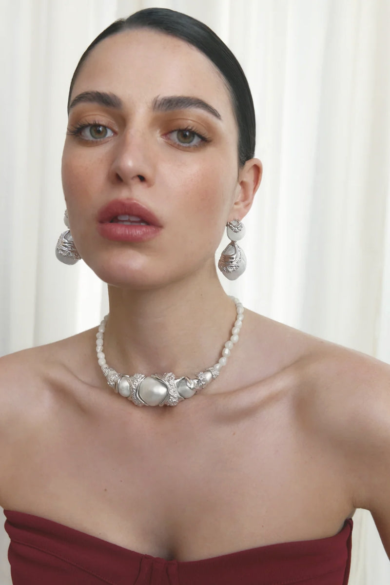 Jude Benhalim cascade earrings with rhodium-plated white finish, featuring a flowing, multi-tiered design for elegant style.