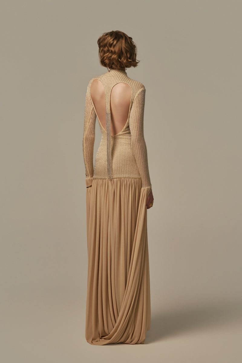 Poem Cascade Gown in Warm Sand color, flowing elegant dress with a layered cascade design, modeled on a woman.
