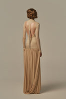 Poem Cascade gown in warm sand color, elegant long dress with flowing fabric and stylish design, worn by a model.