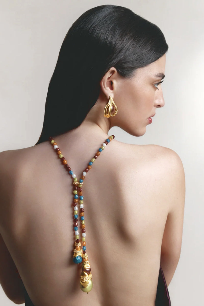 Gold mixed metal cascade necklace by Jude Benhalim featuring layered, flowing chain design on a neutral background.