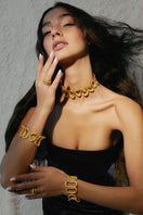 Gold Cassandra bracelet by Jude Benhalim, featuring elegant design with intricate chain links and modern jewelry style.