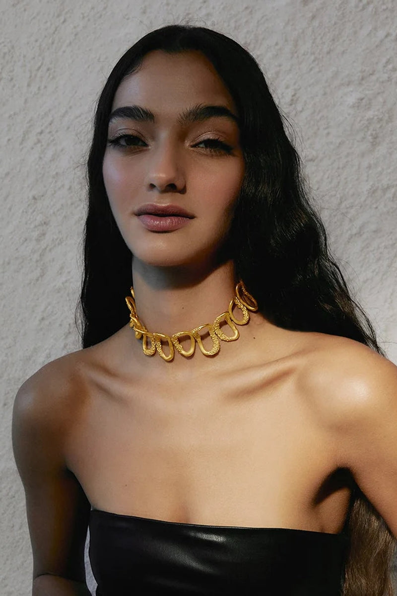 Gold Cassandra choker necklace by Jude Benhalim featuring a sleek, minimalist design on a plain background.