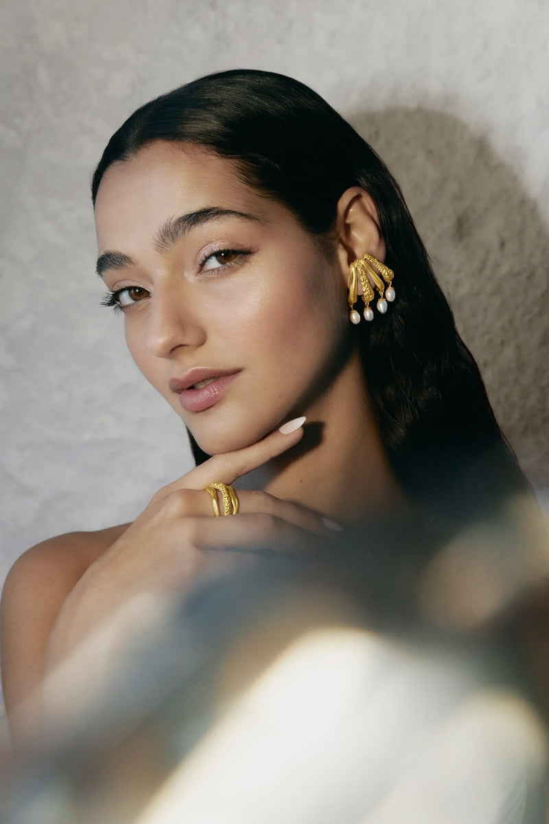 Gold Cassandra earrings by Jude Benhalim featuring intricate design and elegant dangle style for sophisticated look.
