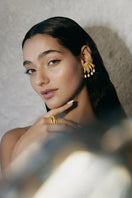 Gold Cassandra earrings by Jude Benhalim featuring intricate design and elegant dangle style for sophisticated look.