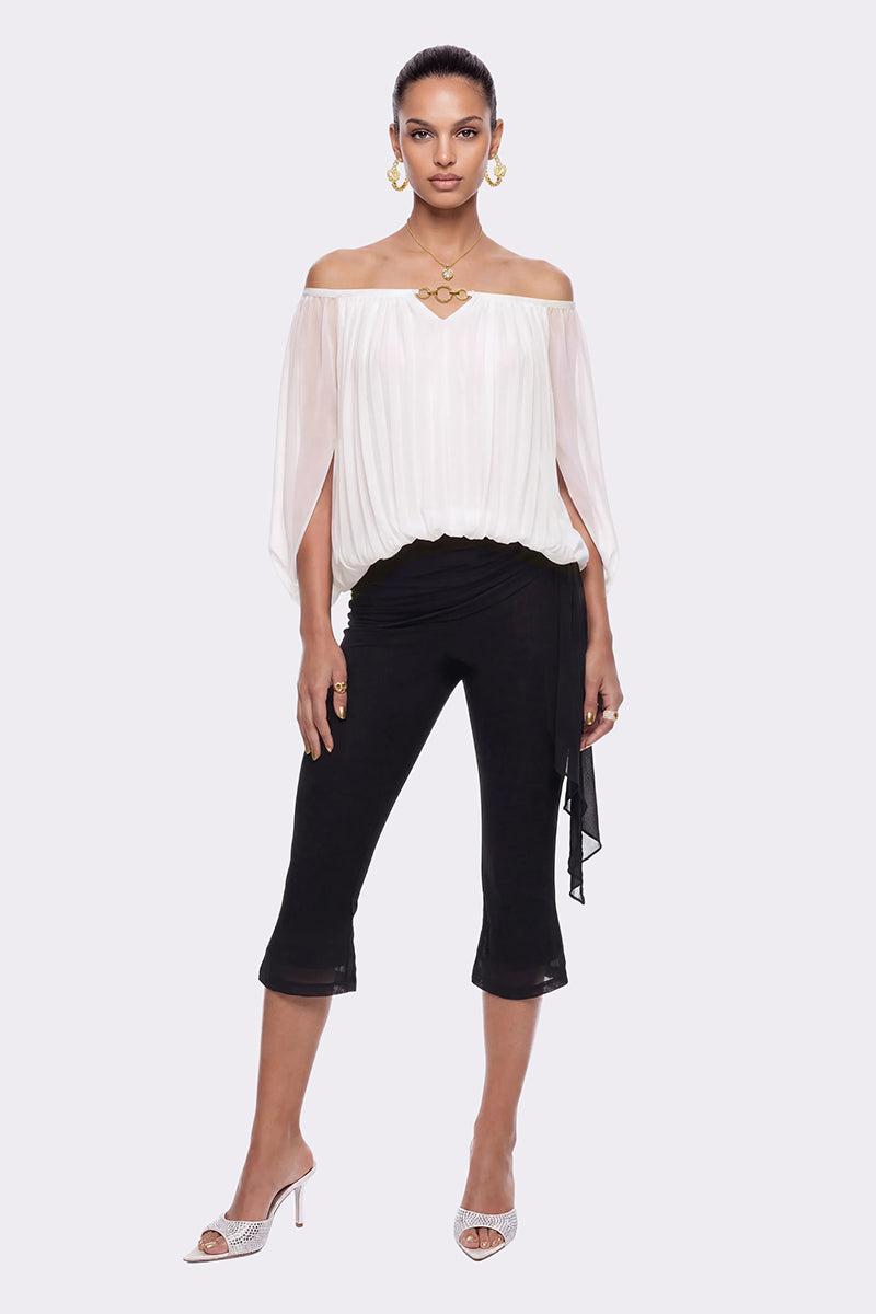 Black Cassia Capri flared pants by Nana Jacqueline displayed on a model in a lookbook photo.