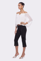 Black Cassia Capri flared pants by Nana Jacqueline, shown styled with a relaxed fit and wide leg silhouette.