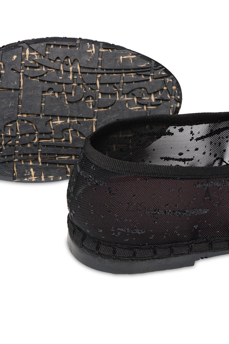 Black glitter mesh flats by Flabelus with a sleek design, perfect for stylish and comfortable everyday wear.