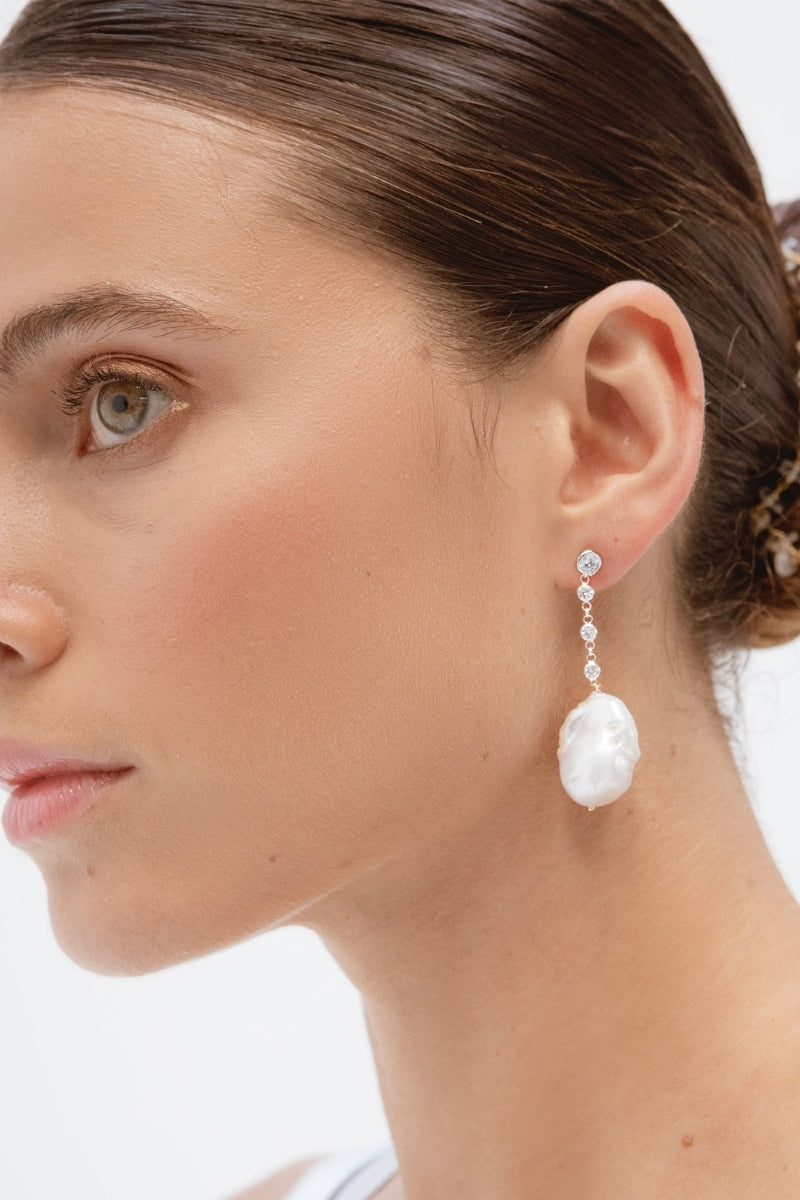 Silver baroque pearl earrings from CELINE, featuring elegant design with lustrous pearls, by LAVANI JEWELS.