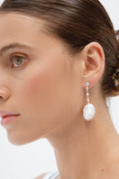 Silver baroque pearl earrings by Celine featuring elegant design, displayed on a white background with a simple, sophisticated style.