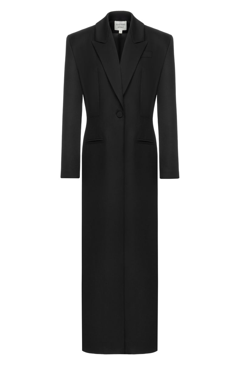 Matters black Celine coat displayed on a hanger, showcasing its sleek design and tailored fit in a close-up view.