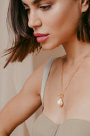 Sara Shala Chantra pearl chain necklace featuring a single elegant pearl on a delicate chain, styled for a modern look.